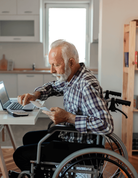 Image of a disabled elderly man using a laptop