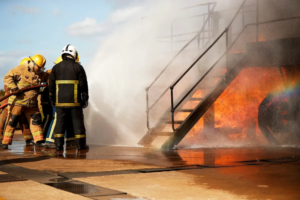 A team of firefighters work together to put out a building on fire