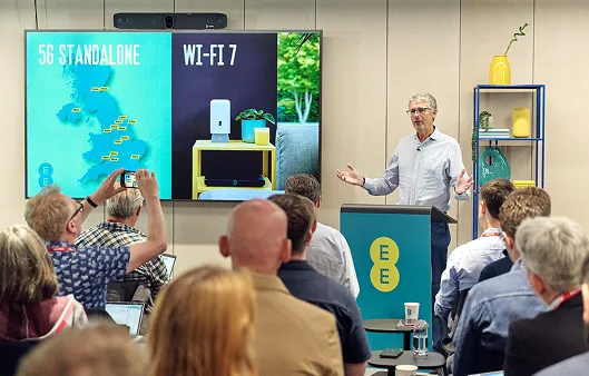 A man presents a slide on EE's 5G networks to a crowd