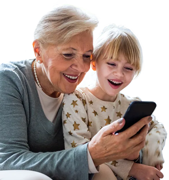 An older woman and a young girl looking at a smartphone