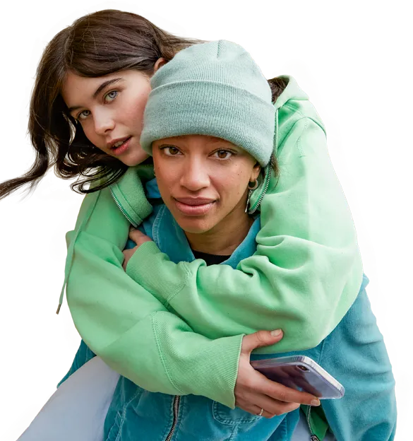 A teenager piggybacks another teenager, holding a smart phone