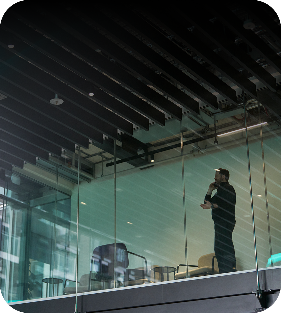 A person on a phone call looking out of a window