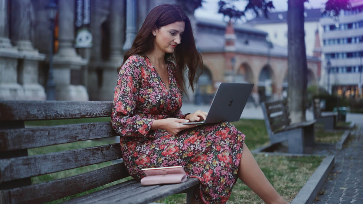 Lady in a floral dress working on a laptop