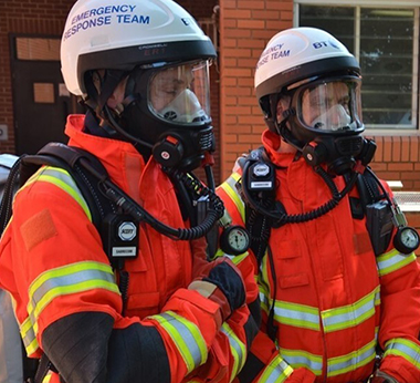 Two team members wearing breathing apparatus