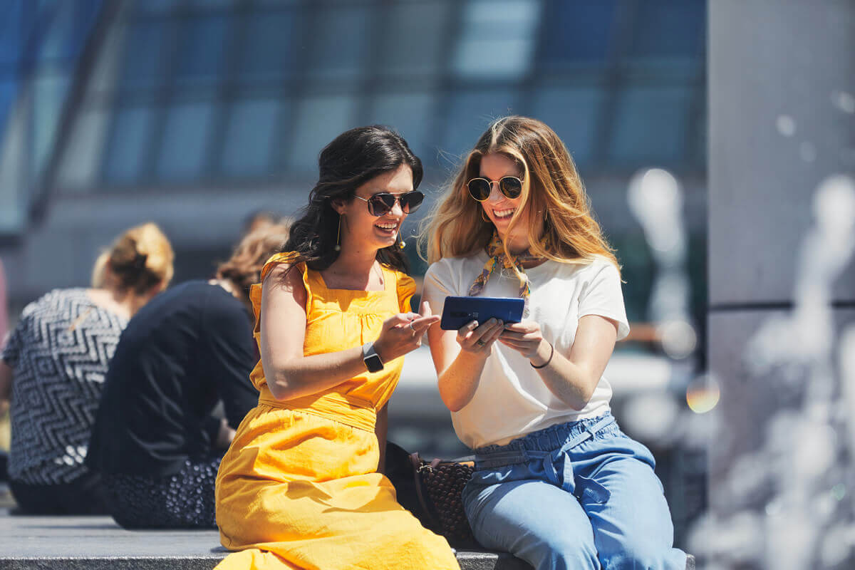 Two women looking at a mobile phone