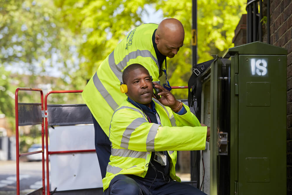 Two engineers working at a fibre box