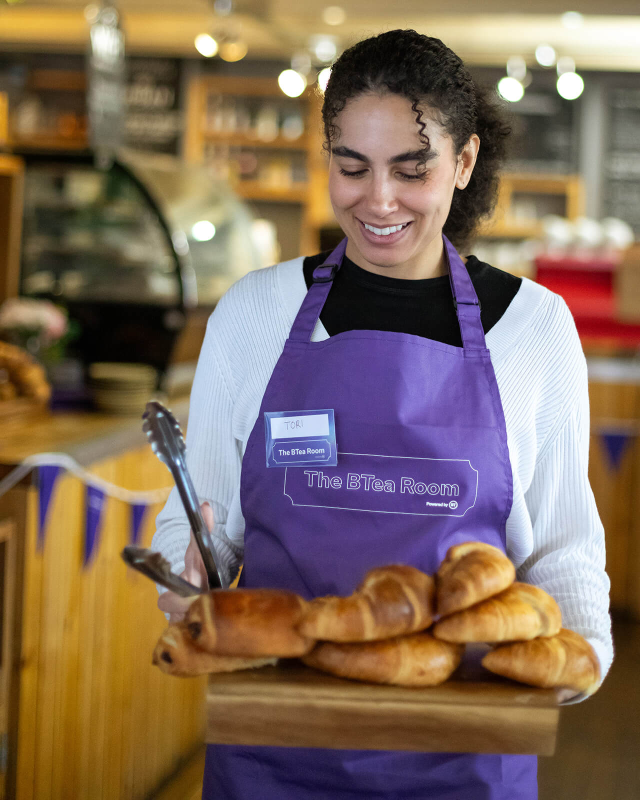 BTea Room waitress holding a tray of croissants 