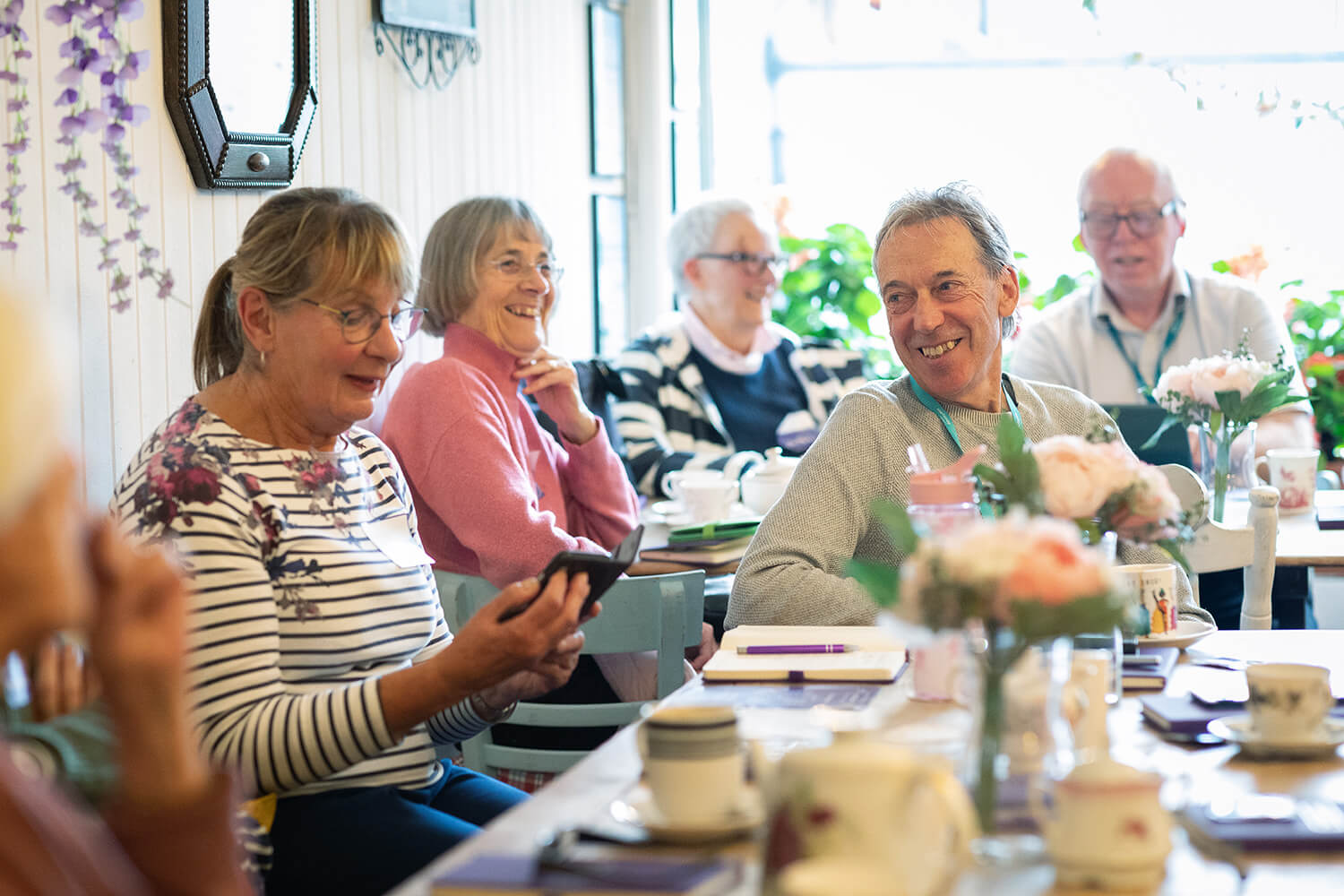 Group of people enjoying a cuppa and cake at a BTea Room event