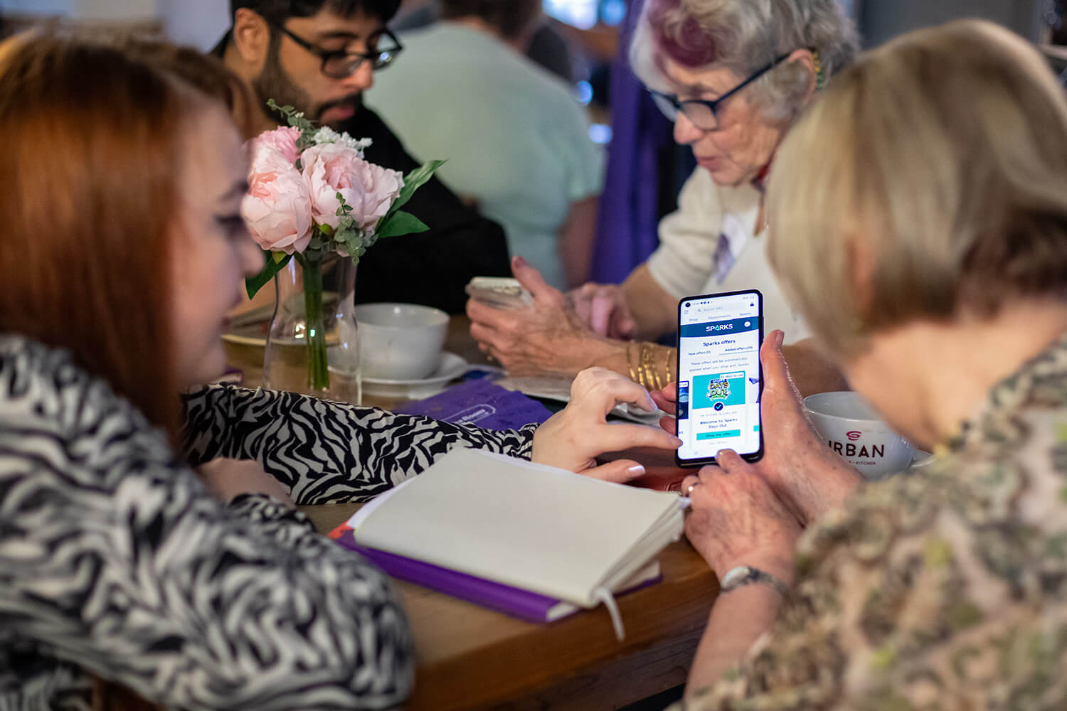 AbilityNet volunteer explaining how to use a smartphone