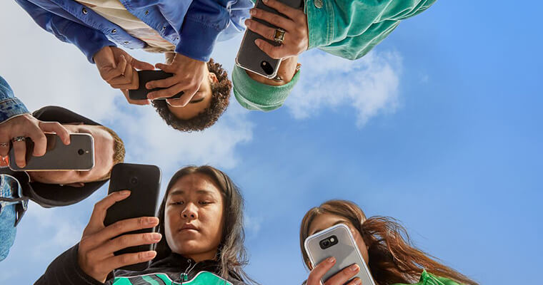 Group of teenagers on their mobile phones