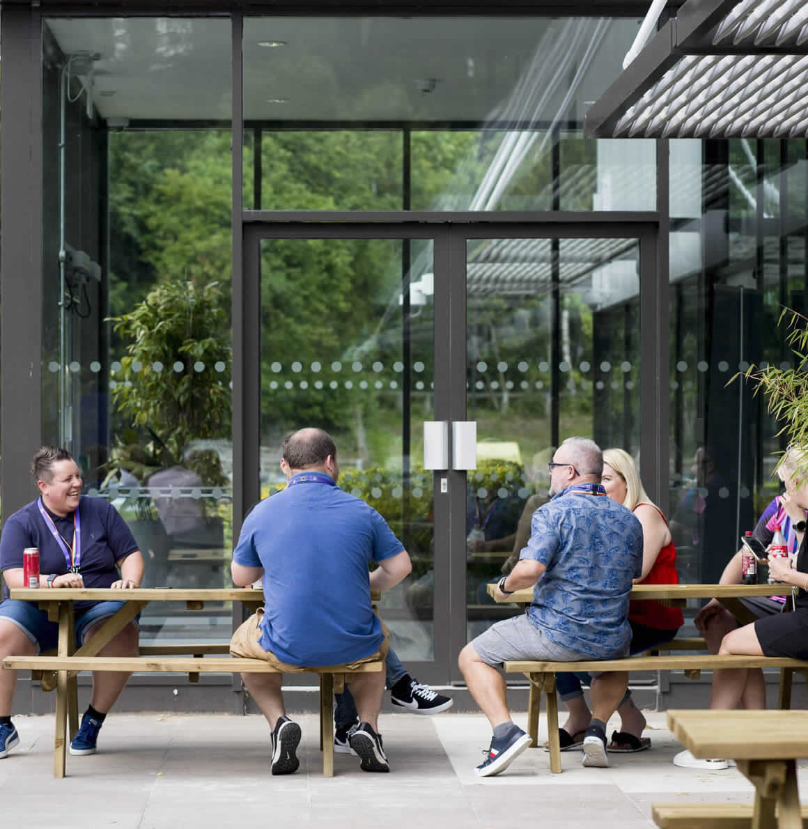 Contact centre colleagues eating lunch outside on bench