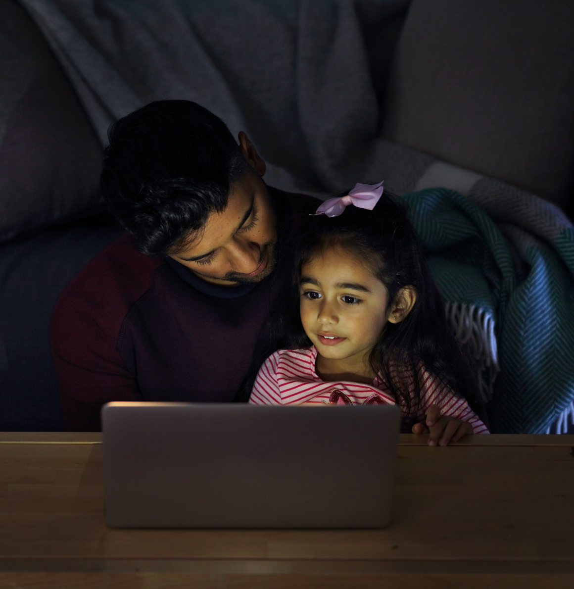 Father and daughter using a laptop