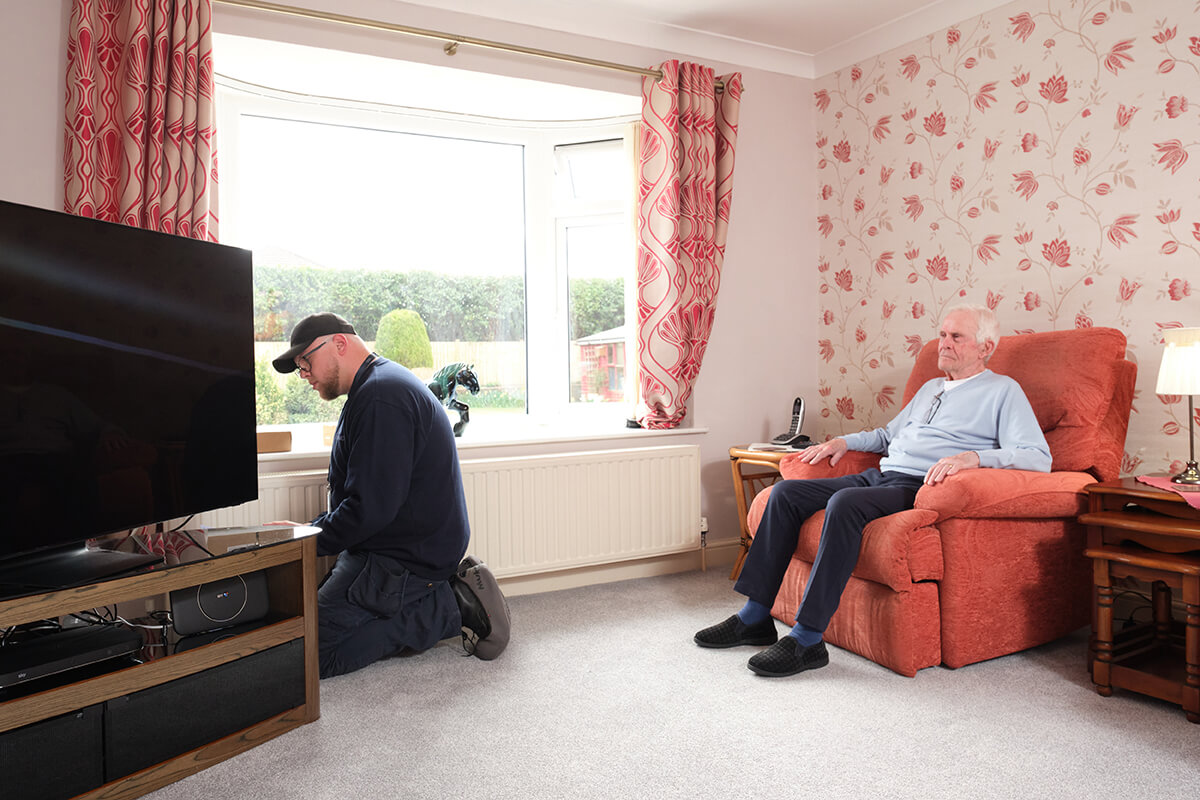 BT engineer visiting an elderly customer