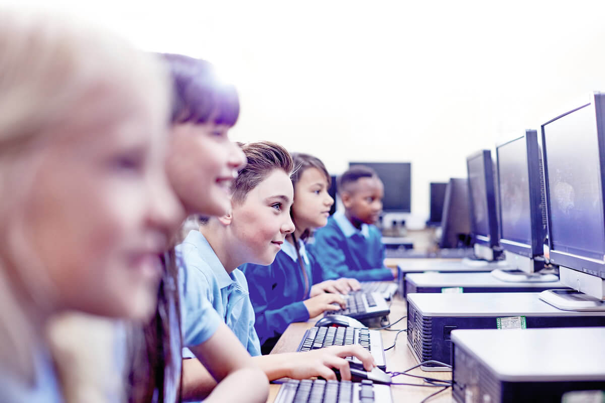 Group of young students looking at computer screens