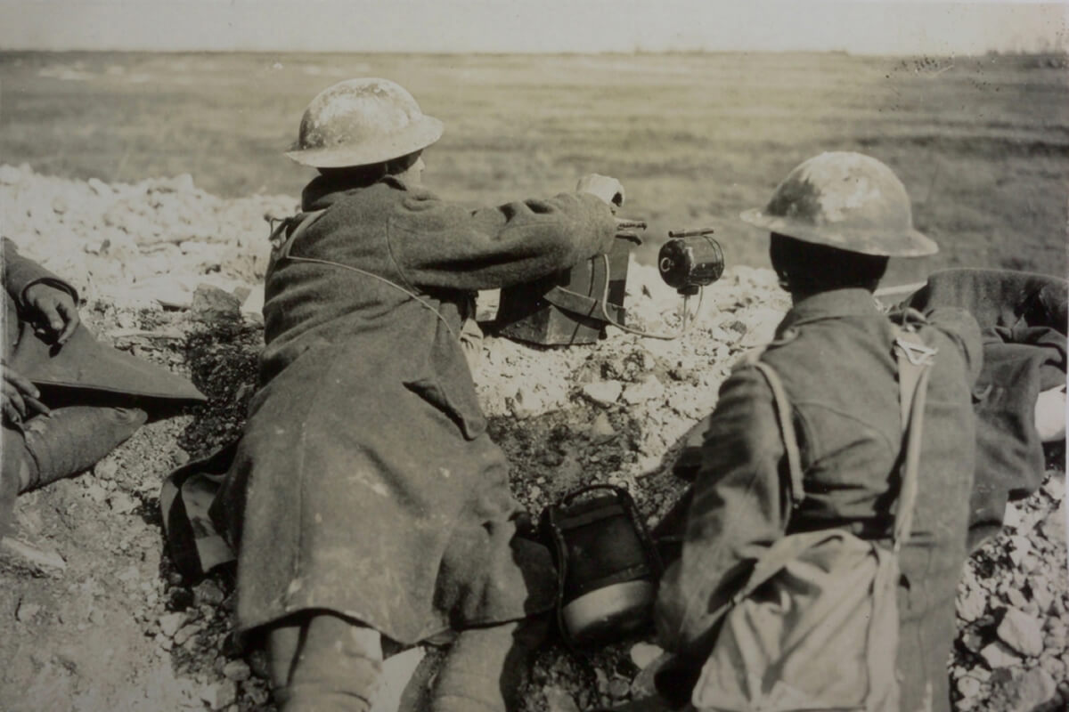 Soldiers using light signalling equipment in the trenches