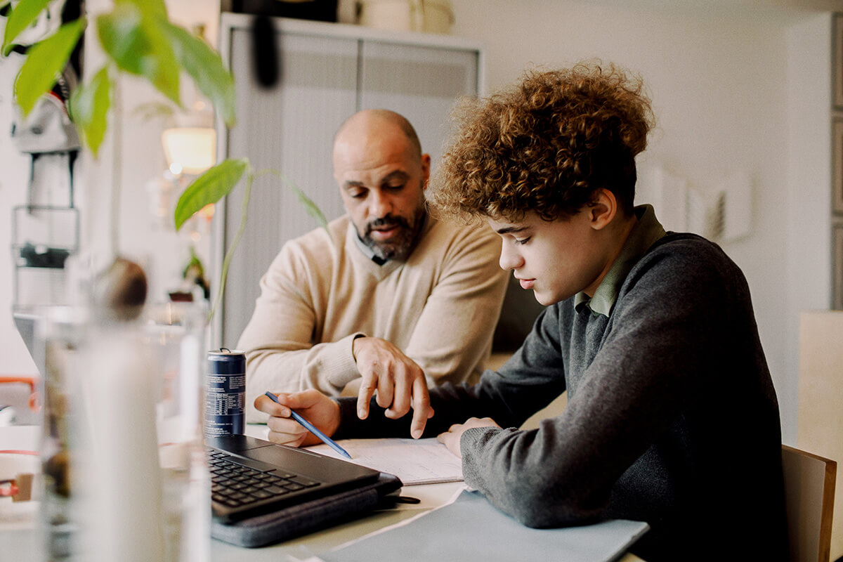 Man and boy studying