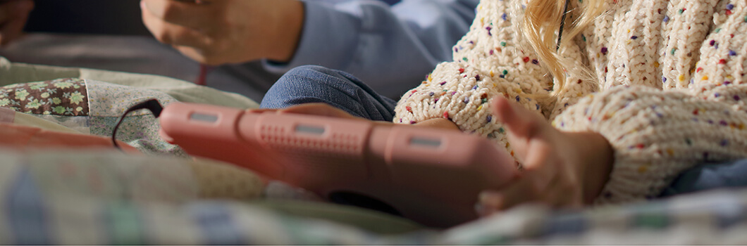 Child using a pink tablet