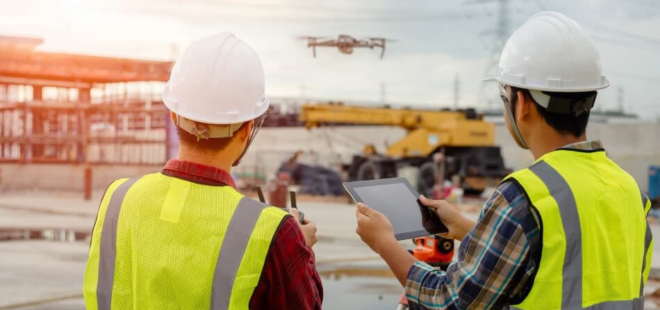 Workmen operating a drone