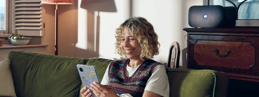 Person at home using a tablet near a BT Smart Hub